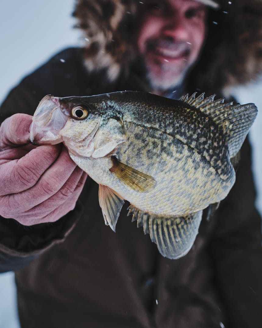 Ice fishing scene on a frozen lake during a winter fishing session